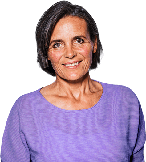 Middle-aged woman with short hair wearing lavender sweater smiling