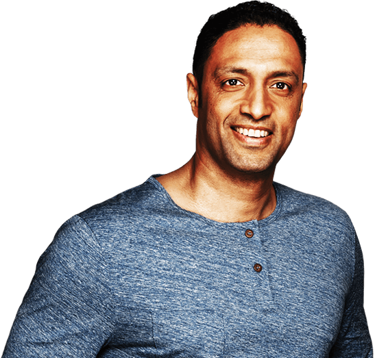 Man with dark hair and blue shirt smiling