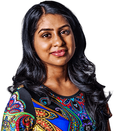 Smiling woman with long dark hair wearing a colorful shirt