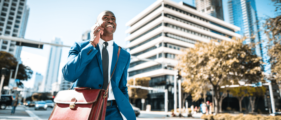 A man dressed in a suit is walking down the street in one of the best cities to live and work in the US.